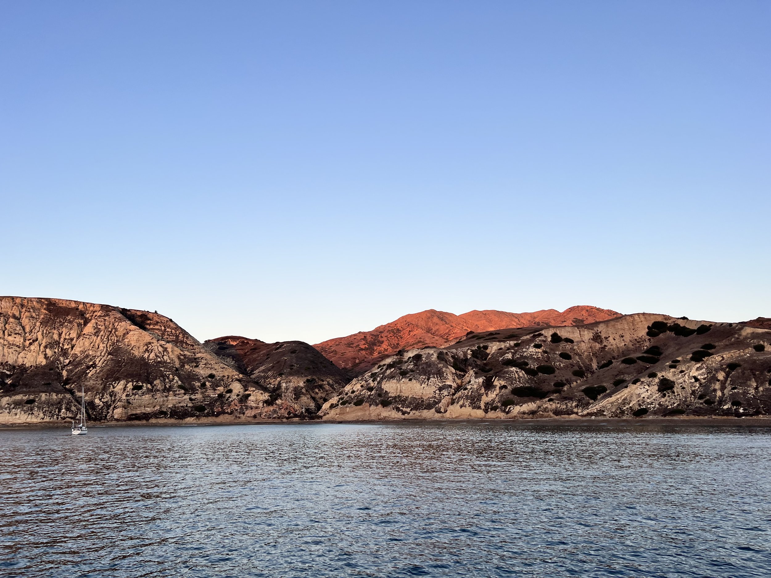 Early morning at Yellowbanks anchorage, sunlight on Santa Cruz Island
